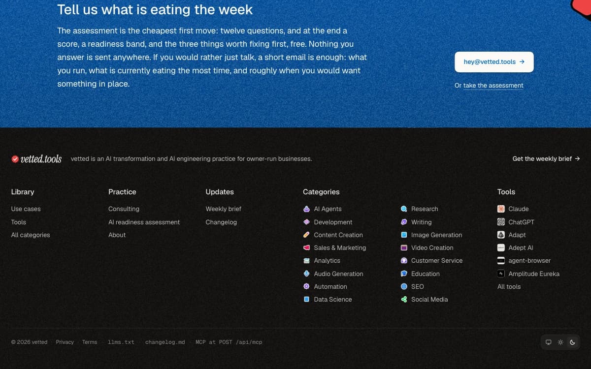 The foot of the home page in the dark theme, with the System, Light and Dark switch at the bottom right.